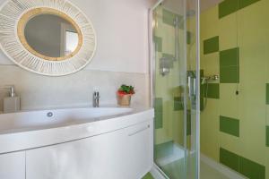 a bathroom with a white sink and a mirror at Isola Bella Apartment in Barghe +30 photos