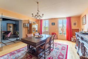 a dining room with a wooden table and chairs at Les Conils in Saint-Pierre-de-Vassols