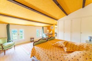 a bedroom with a large bed and a chair at Les Conils in Saint-Pierre-de-Vassols +38 photos