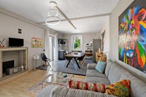 a living room with a couch and a table at Isola Bella Apartment in Barghe