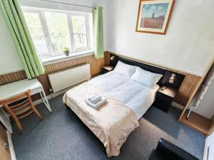 a small bedroom with a bed and a desk at Azalea Studio - Self Contained One-Bed Studio Flat in Oxford