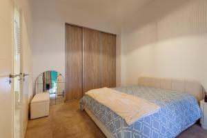 a bedroom with a bed and a closet and a mirror at Le Castel in Marseille