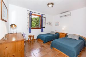 a bedroom with two beds and a desk and a window at Alojamiento con encanto in Binibeca +23 photos