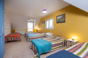 a room with four beds in a room at Villa - Piscine, jacuzzi, sauna in Plouharnel +24 photos