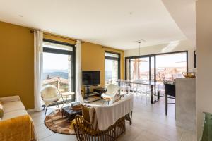 a living room with a couch and chairs and a table at A Chiusella in Belgodère