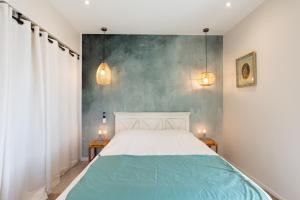 a bedroom with a bed with two tables and two lamps at A Chiusella in Belgodère +18 photos