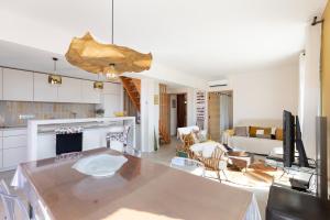 a kitchen and living room with a table and a couch at A Chiusella in Belgodère