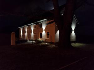 a building with lights on the side of it at night at Kleine Auszeit 2 in Forst +4 photos
