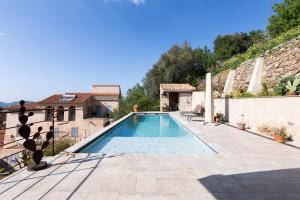 a swimming pool in the middle of a house at A Chiusella in Belgodère