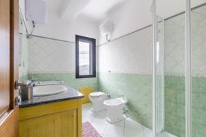 a bathroom with a toilet and a sink and a shower at Casa Cuccureddu in Jerzu +41 photos