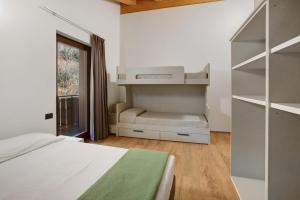a bedroom with a bed and a book shelf at Chalet Serenella in Valdidentro