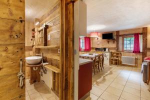 a kitchen and dining room with wooden walls at Maison Peroulaz Charvensod in Charvensod +146 photos