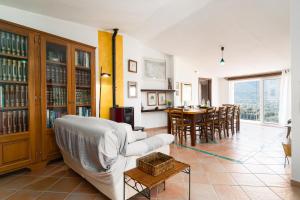 a living room with a couch and a table at Casa Su Craminu in Dorgali
