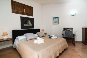 a bedroom with a bed with two teddy bears on it at Casa Su Craminu in Dorgali