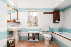 a bathroom with a toilet and a sink at Casa Su Craminu in Dorgali +26 photos