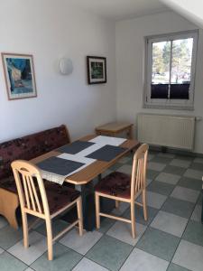 a dining room with a table and two chairs at Appartment Isabelle Sky in Lake Pressegg