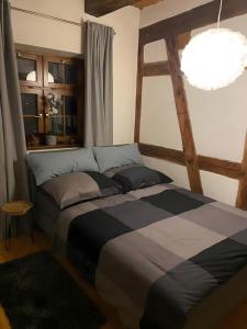 a bedroom with a bed and a large window at Ulmer Spatzennest in Ulm
