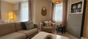 a living room with a couch and a chair at Ferienwohung Traumgarten in Obereisenheim +18 photos