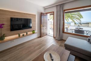 a living room with a flat screen tv and a couch at Callao in Playa Honda