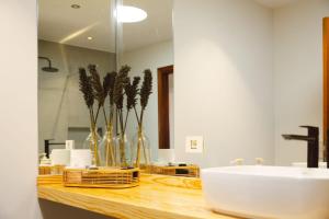 a bathroom with a counter with a sink and a mirror at Callao in Playa Honda +22 photos