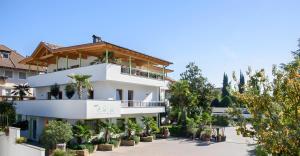 a large white building with trees in front of it at Peter Paul Terrassenapp Hocheppan in Appiano Sulla Strada Del Vino