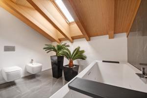 a bathroom with a sink and a toilet at Luxury Lakefront Penthouse in Lezzeno +18 photos