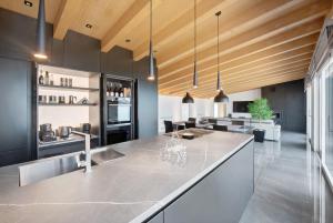 a kitchen with a large island in a room at Luxury Lakefront Penthouse in Lezzeno