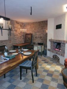a dining room with a table and a fireplace at Thum'scher Hof in Ortenberg