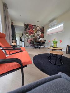 a living room with a red couch and a table at Sallands Boschalet in Haarle