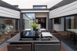 an outdoor dining area with a table and chairs at Beau Loft Lorient - centre ville in Lorient +15 photos