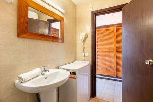 a bathroom with a sink and a mirror at Estudio Mirada 309 in Es Pujols +12 photos