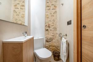 a small bathroom with a toilet and a sink at Sierra De Majalinos in Ejulve +15 photos