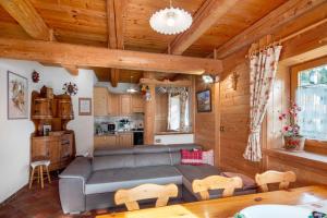 a living room with a couch and a table at Appartamenti Marmolada Falcade in Falcade