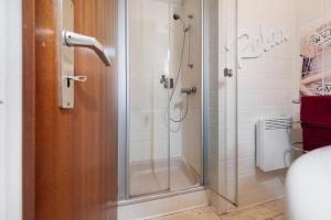 a shower with a glass door in a bathroom at Apartment Seeadler in Butjadingen +14 photos