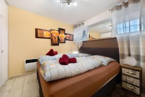a bedroom with a bed with red pillows on it at Apartment Seeadler in Butjadingen