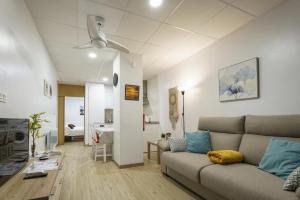 a living room with a couch and a table at Sophie Apartamentos - Burela in Burela de Cabo
