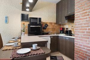 a kitchen with a counter with a microwave and a sink at Apartment Seeadler in Butjadingen