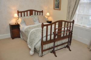 
a bedroom with a bed and a lamp at Bank House B and B in Penrith
