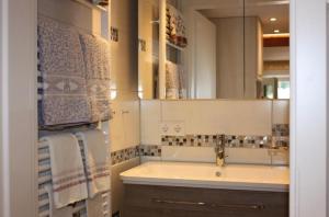 a bathroom with a sink and a mirror and towels at Ferienwohnung Landidyll in Enzklösterle +10 photos