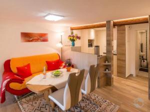 a dining room with a table and chairs and a kitchen at Ferienwohnung Landidyll in Enzklösterle