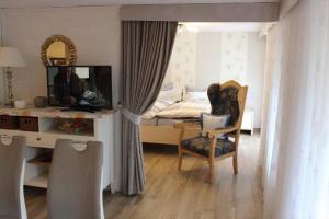a bedroom with a bed and a desk and a chair at Ferienwohnung Landidyll in Enzklösterle
