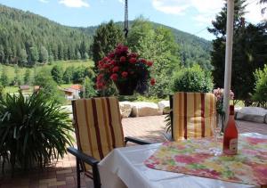 a table with a bottle of wine sitting on a patio at Ferienwohnung Landidyll in Enzklösterle