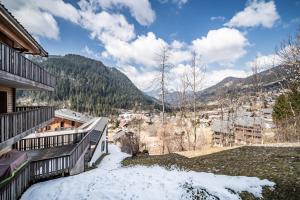 a balcony of a house with snow on the ground at Les loges blanches204 centre chatel in Châtel