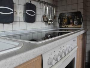a kitchen counter with a sink and a stove at Ferienunterkunft Schrichten in Schmallenberg +23 photos
