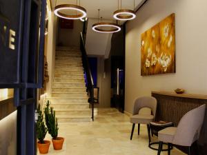 a hallway with two chairs and stairs in a building at Tophane Suites in Istanbul