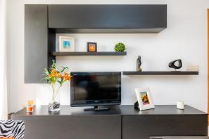 a living room with a television on a desk at Angy Apartment in Alcudia