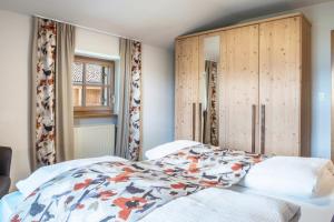 a bedroom with a bed and a wooden cabinet at Schneewittchen Schlosshof in Völs am Schlern