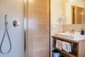 a bathroom with a sink and a shower at Schneewittchen Schlosshof in Völs am Schlern +19 photos