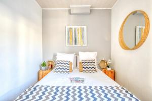 a bedroom with a bed and a mirror at Sur La Route Des Vins - Libourne in Libourne