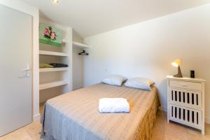 a bedroom with a bed in a white room at La Velle in Mornas
